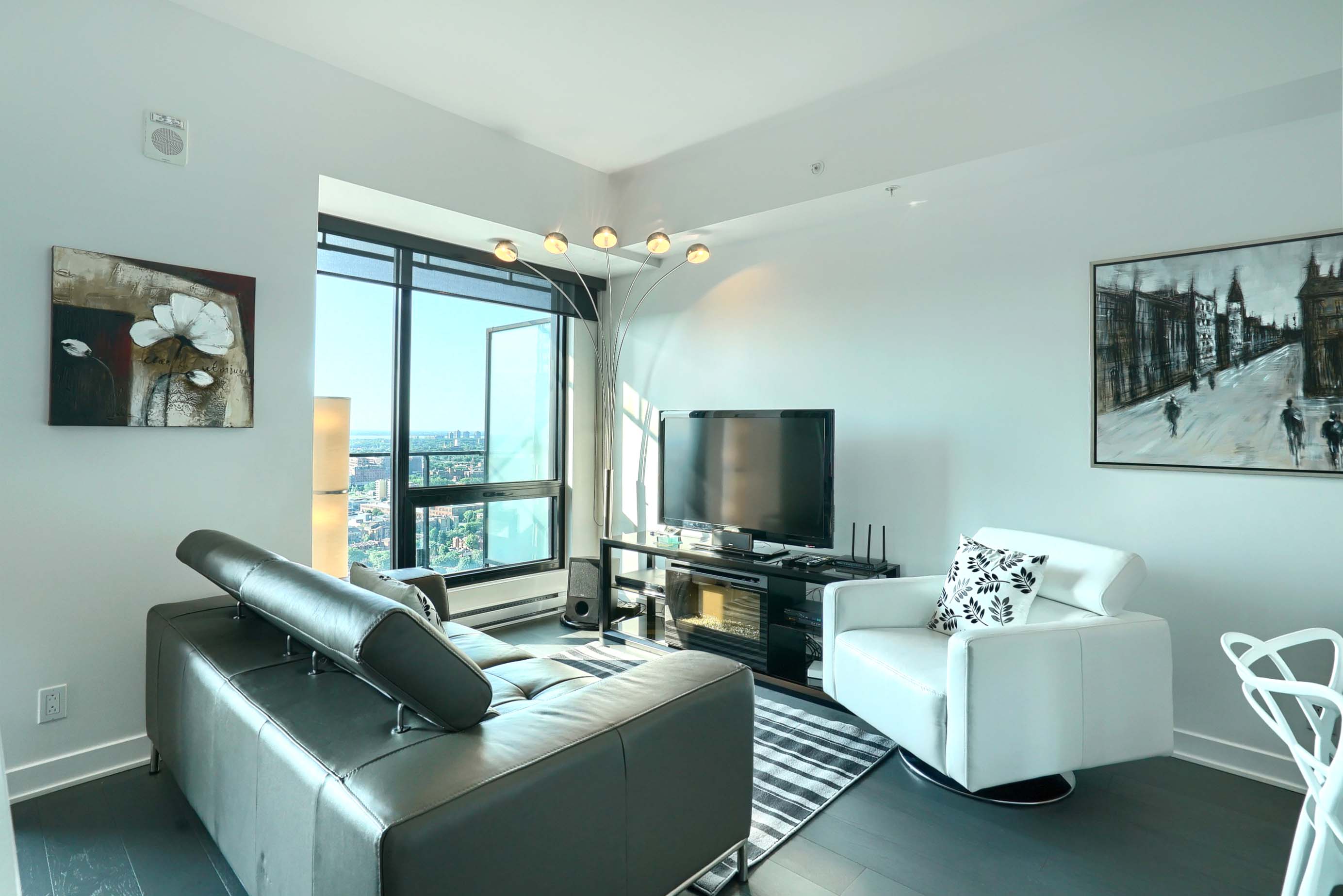 View of the city below from the balcony of this montreal luxury furnished apartment